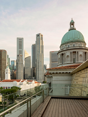 View of a corner at the Coleman Deck and the former Supreme Court dome, with the Singapore skyline in the background