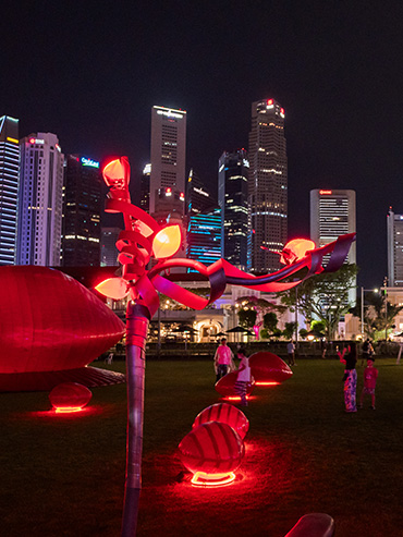Lit up red-coloured art installation at night on the Padang field, during the Light to Night festival