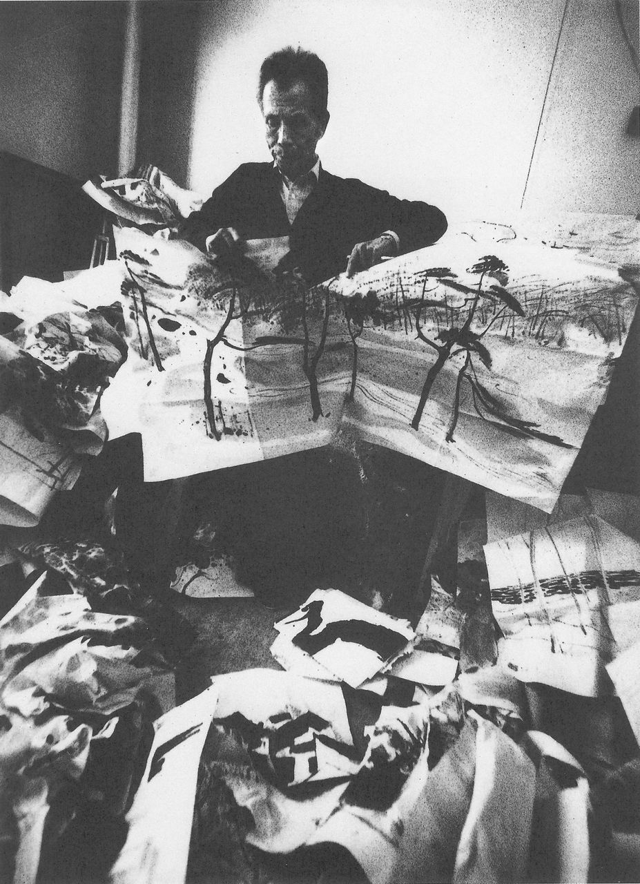 Photograph of Wu Guanzhong destroying several of his paintings