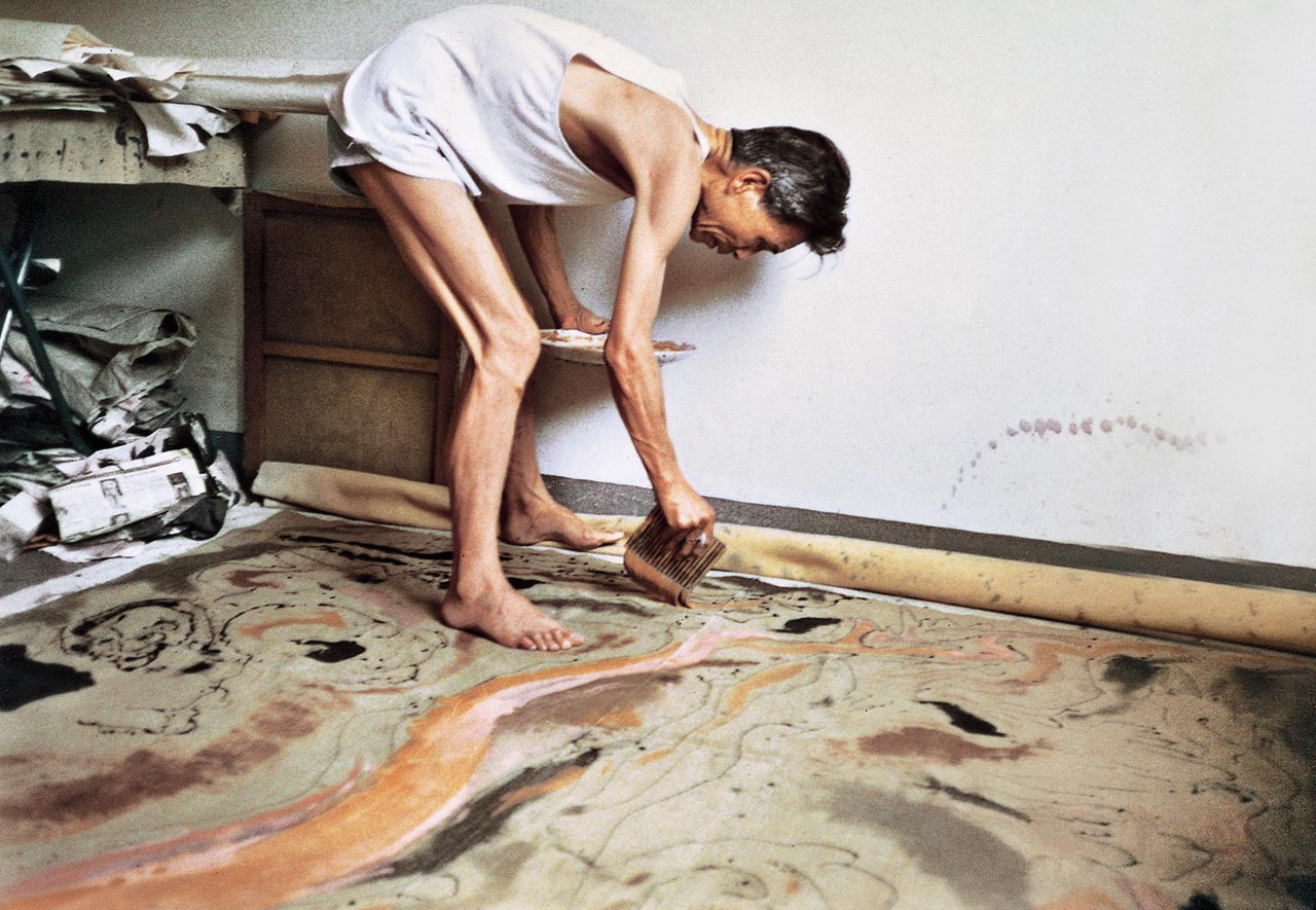 Photograph of Wu Guanzhong painting in a studio at Jinsong, Beijing