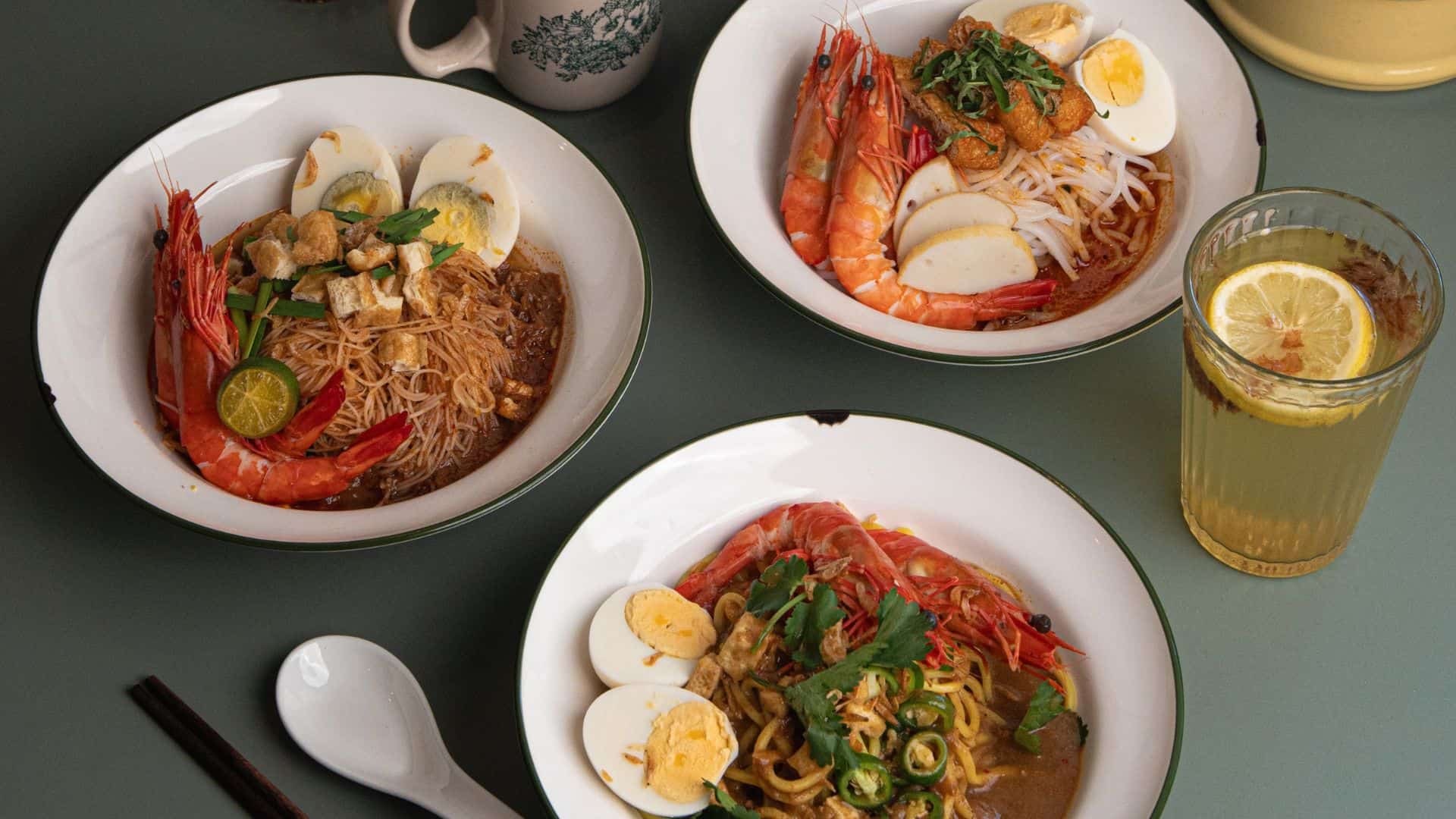 KOPI 1930 and Twenty Eight Cafe- Plate of colourful Nasi Goreng topped with fried egg and garnished with herbs.