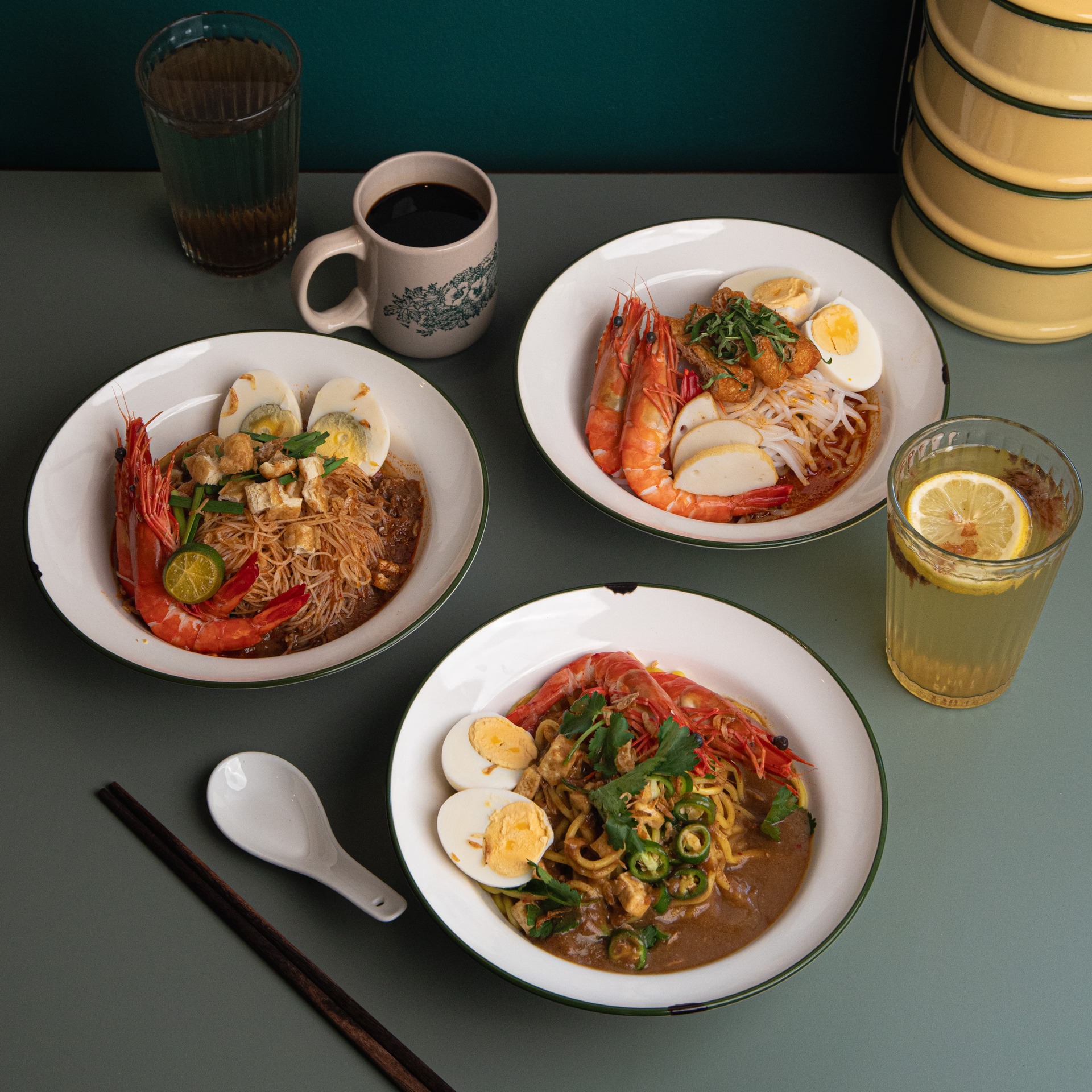 Plate of colourful Nasi Goreng topped with fried egg and garnished with herbs.