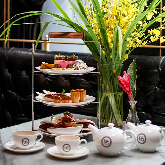 A selection of diverse dishes arranged on white plates, showcasing vibrant colors and textures.
