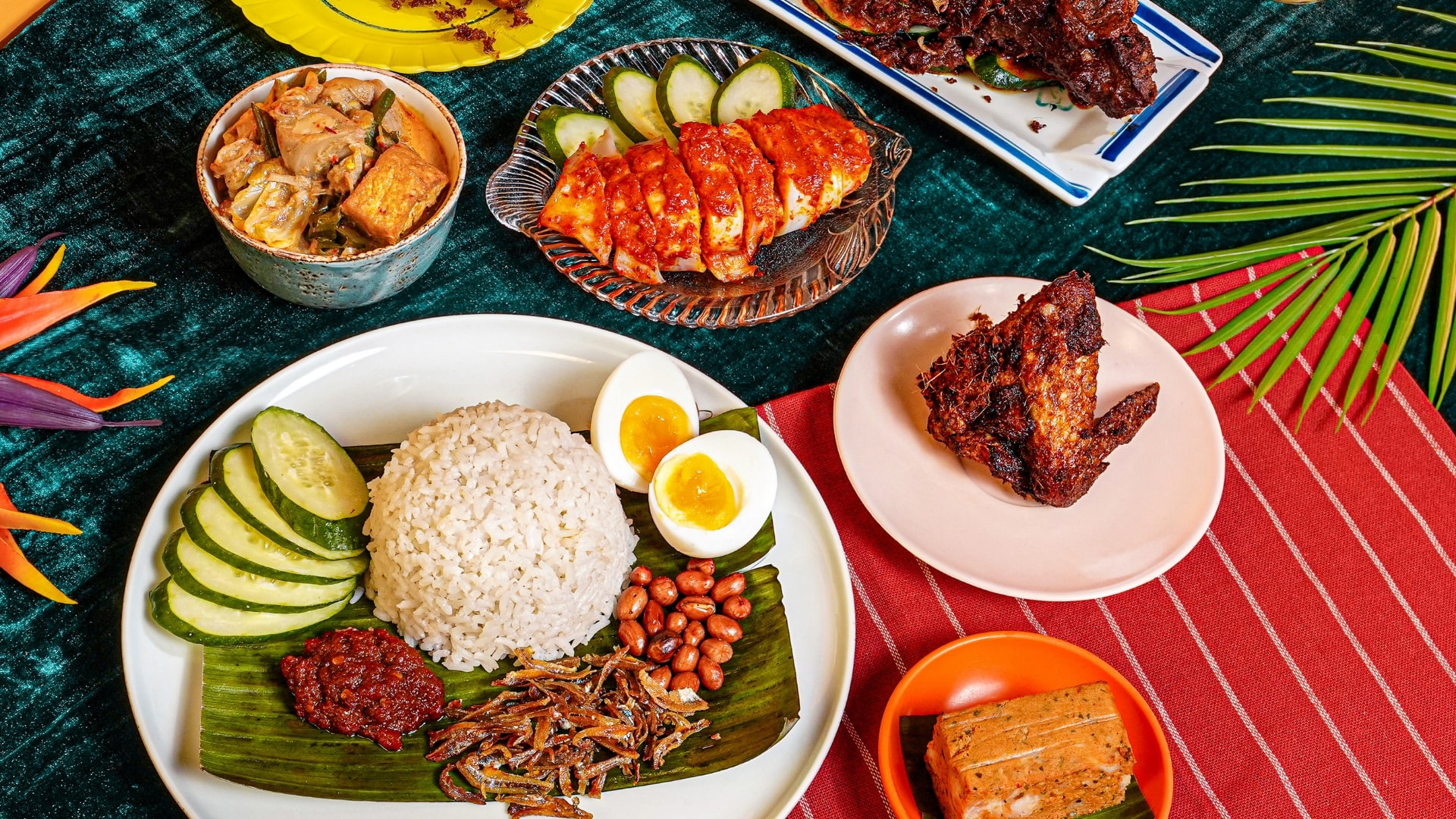 Display of menu items from Rempapa spread out on a green background with red place settings