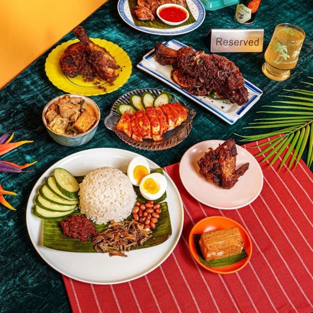 A plate of fried rice garnished with vegetables, showcasing a vibrant and flavorful dish inspired by local Singaporean cuisine.