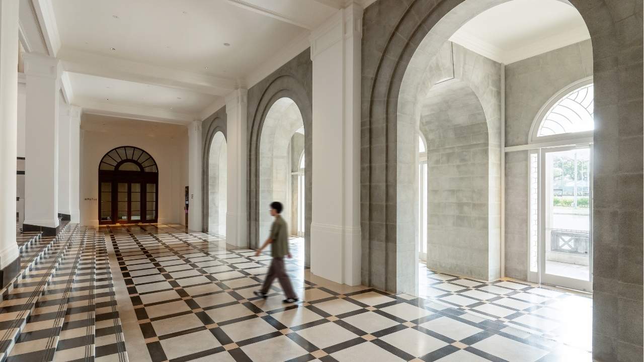 Visitor walking through historic lobby at Supreme Court Wing of the art gallery