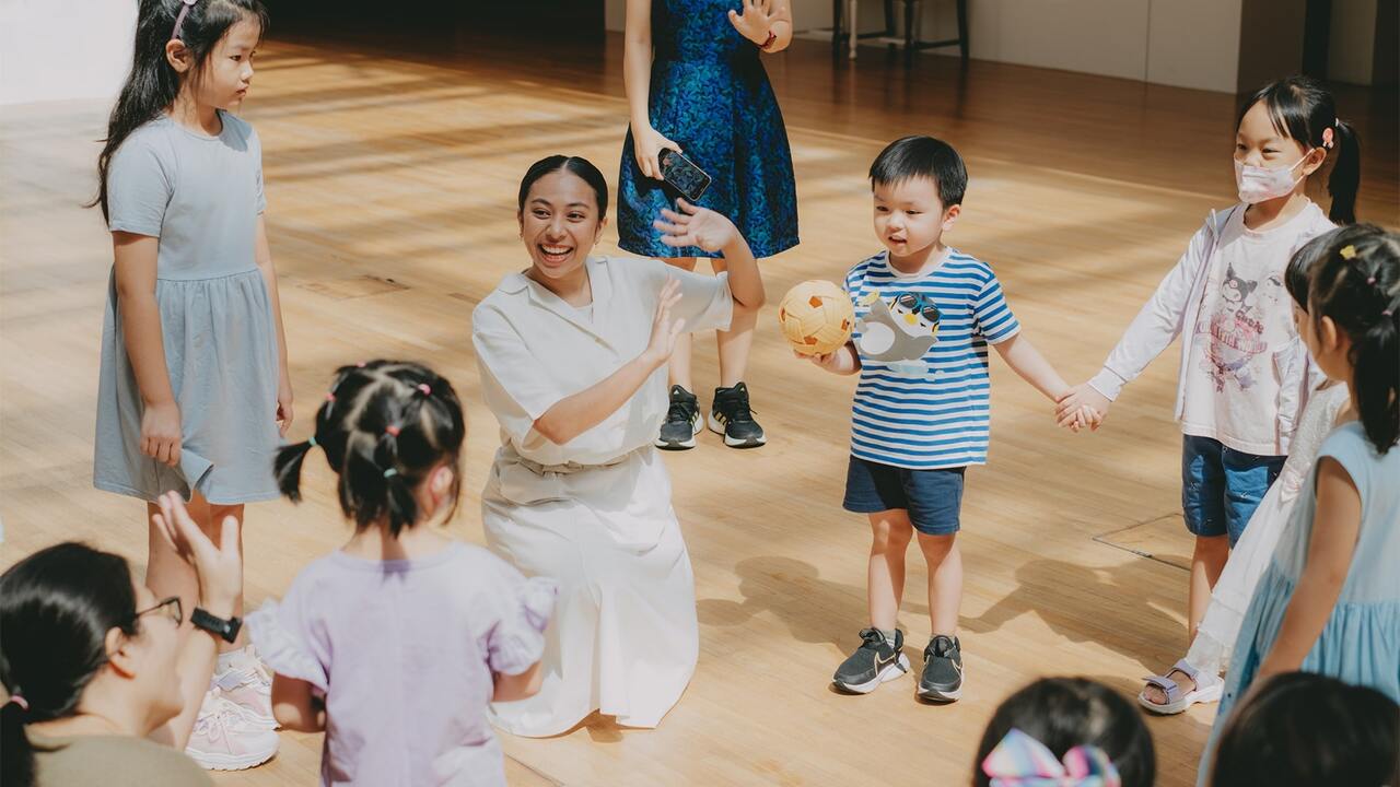 Group of children clapping and cheering during a performance