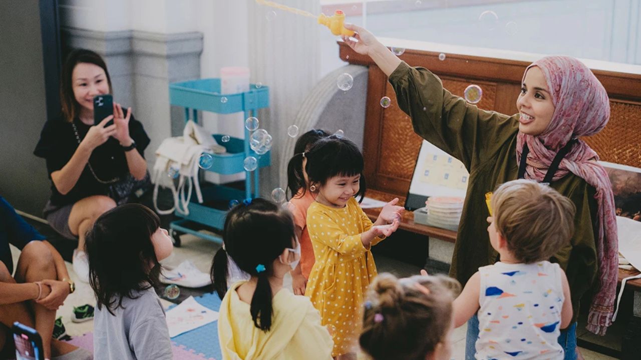 Group of children and their facilitator during a workshop playing with bubbles