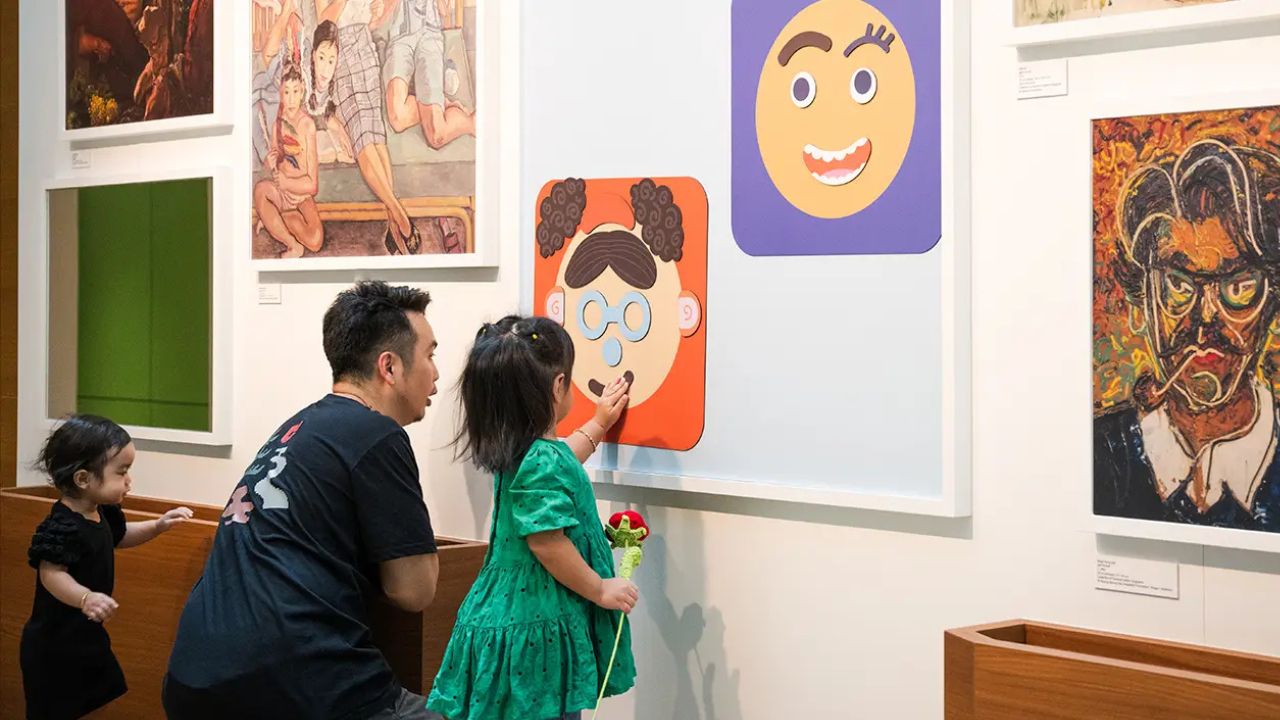Father and his children playing together at the Portrait Gallery, an activity station at KCAE