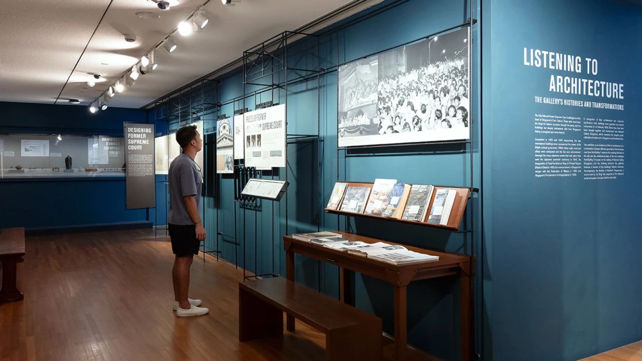 Visitor standing and viewing exhibits from Listening to Architecture