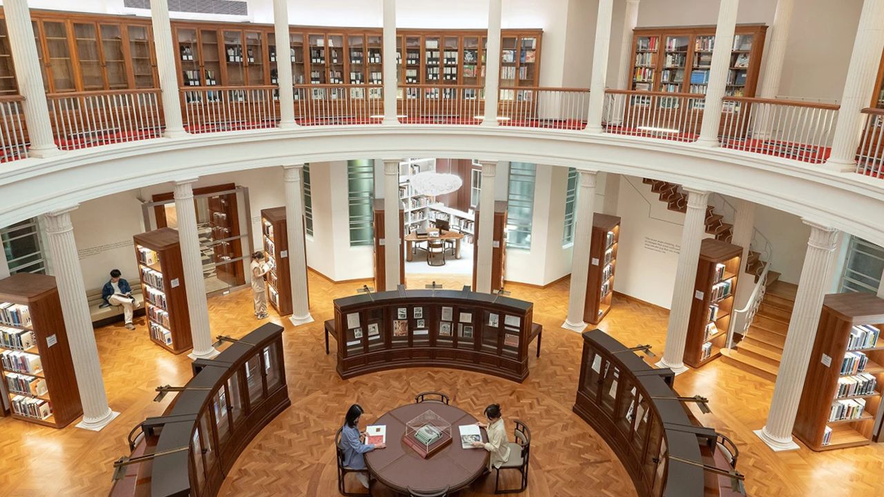 View of circular library with shelves lining the walls and central desk area