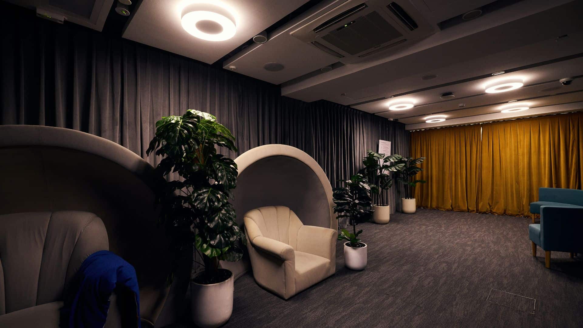 A room with seating pods that create a calming environment for visitors to relax and manage sensory overload.