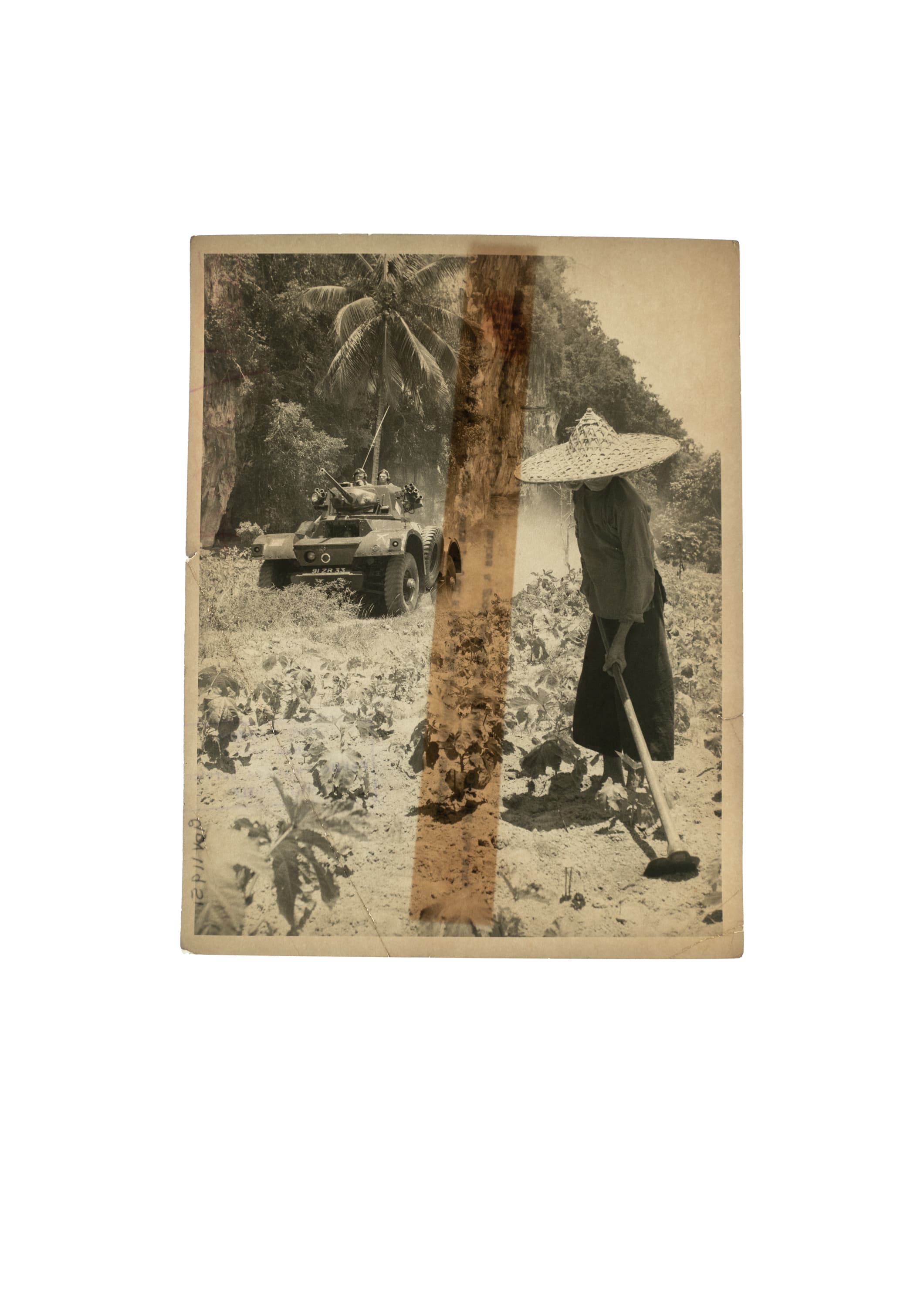 Vintage photograph showing a man standing by a tank while farming, included in Sim Chi Yin's "Interventions: Farming" collection.