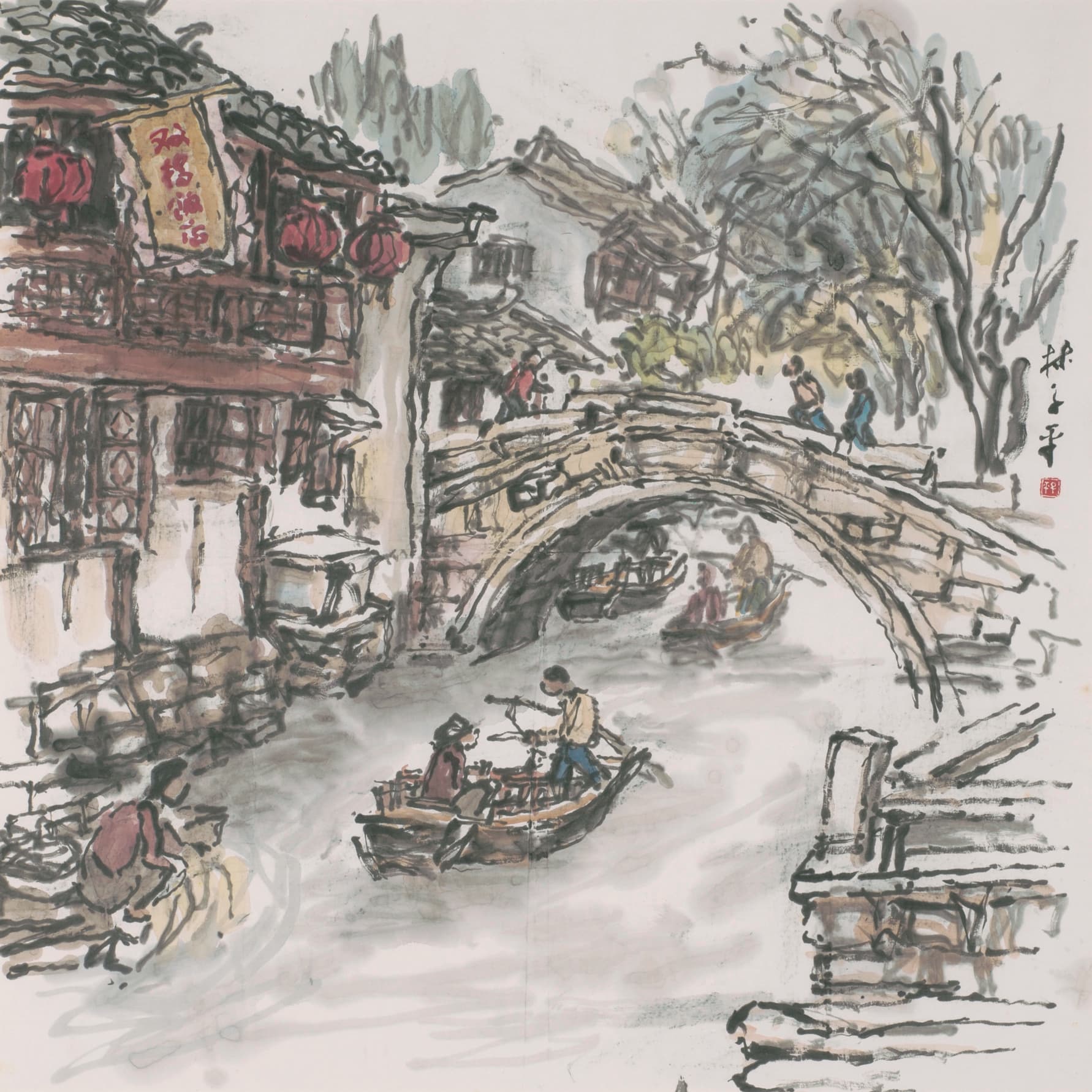 Ink and colour painting of a canal town, with boats passing under a stone arched bridge and red lanterns hanging from a wooden building by the water.