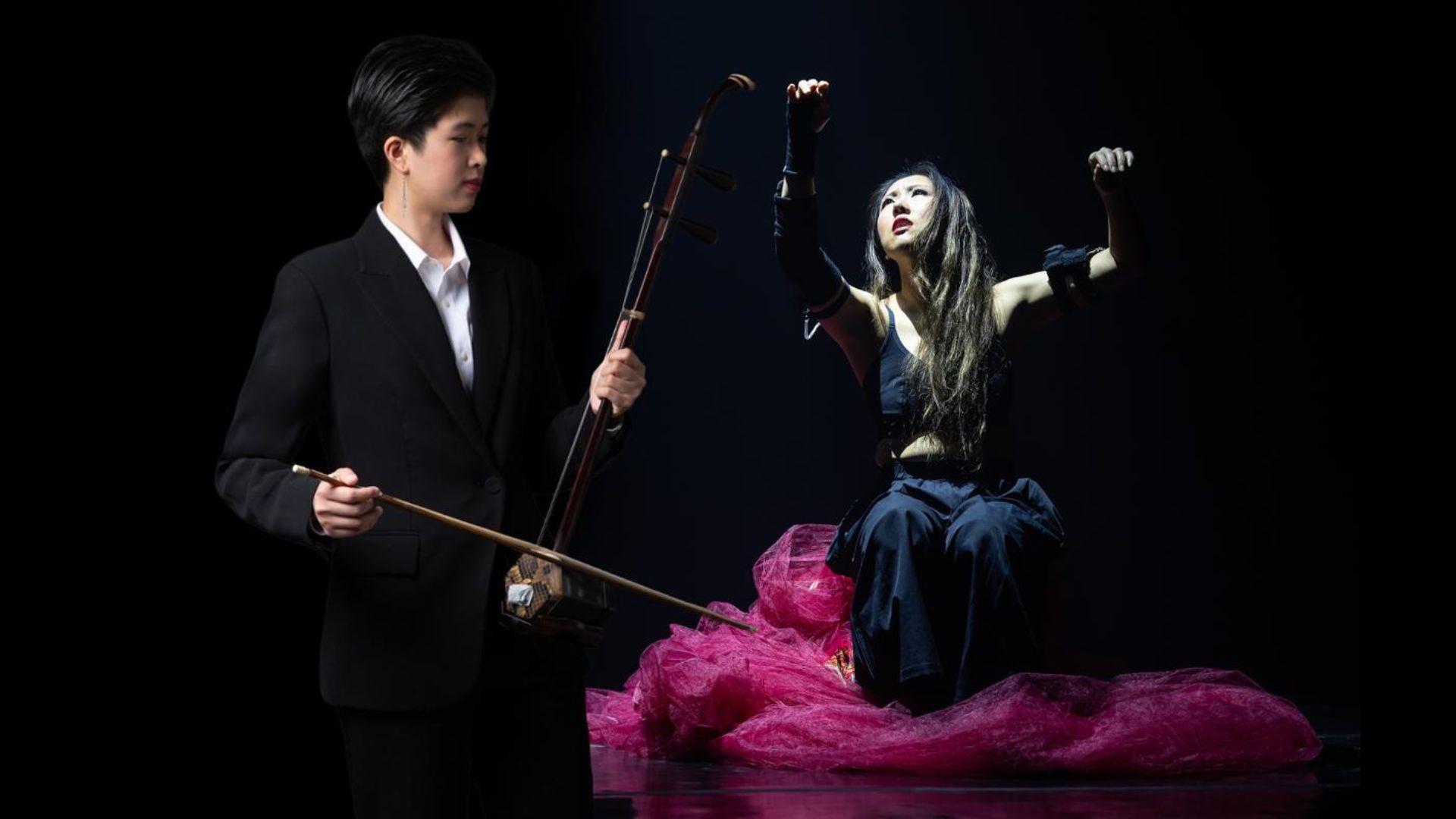 . A man and woman joyfully playing musical instruments together in a vibrant setting.