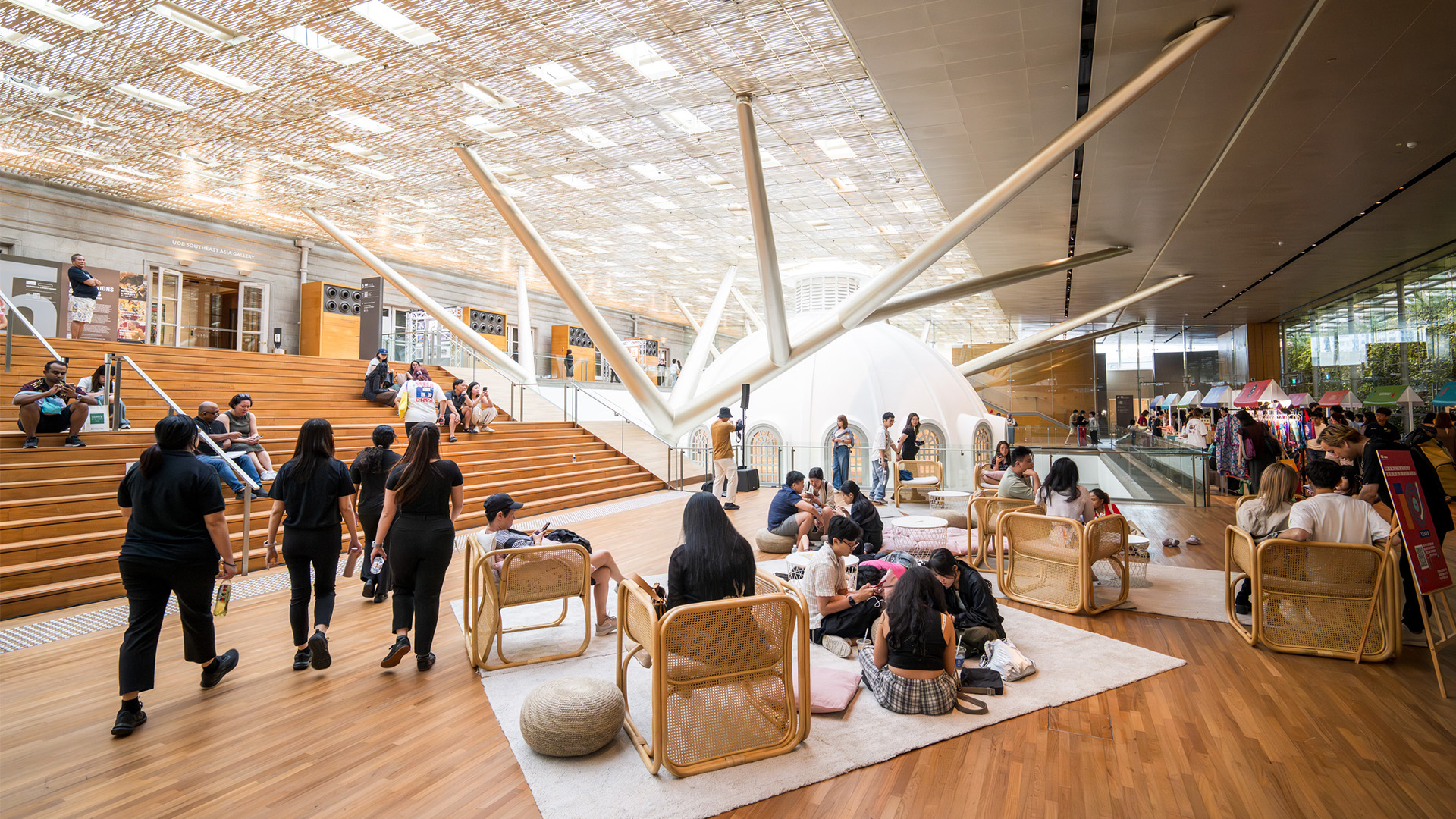 People gathered in a large lobby, sharing ideas and creativity at a one-day event for artists and makers in Singapore.