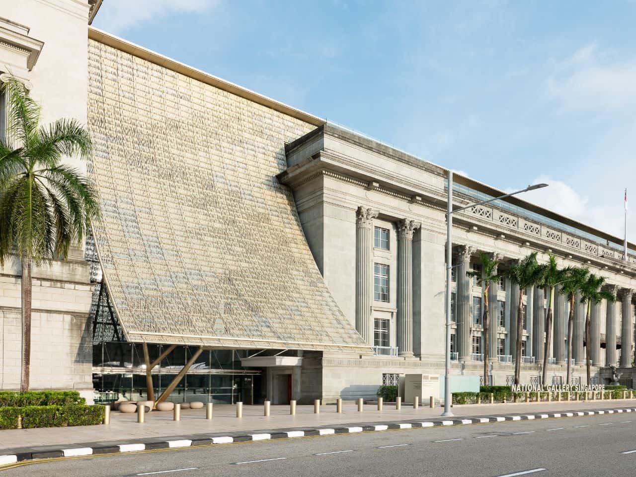 Building Highlights-Interior view of the National Gallery Singapore with white columns and black-and-white tiled steps.
