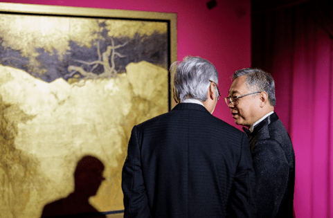 Deputy Prime Minister and Minister for Trade and Industry, Mr Gan Kim Yong, speaking to artist Li Huayi in front of his artwork Pine Breezes in Golden Glow II, which he jointly contributed with the Kwai Fung Hin Art Gallery for the Gala Auction