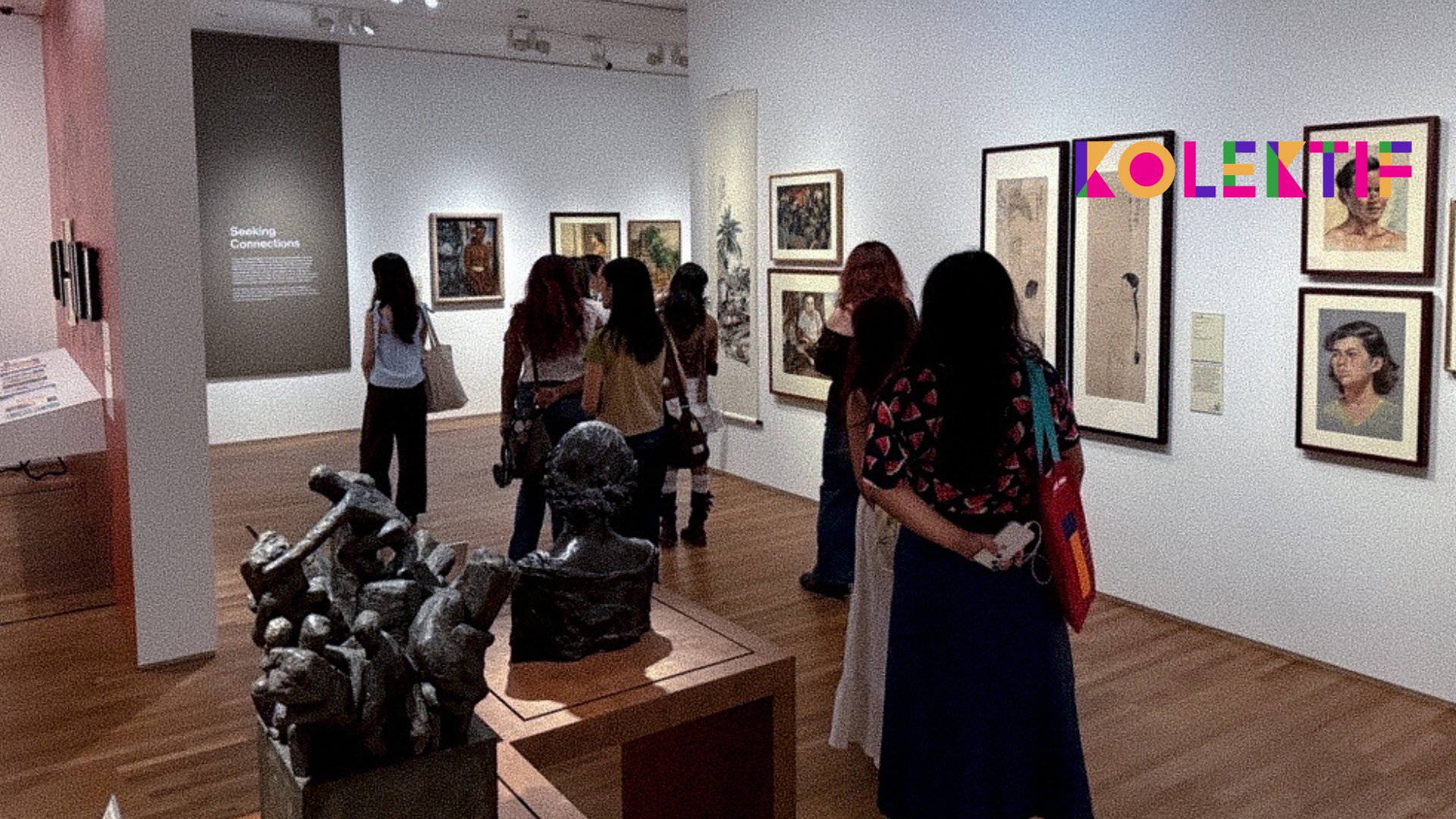Youths observing various artworks in a spacious art museum gallery.